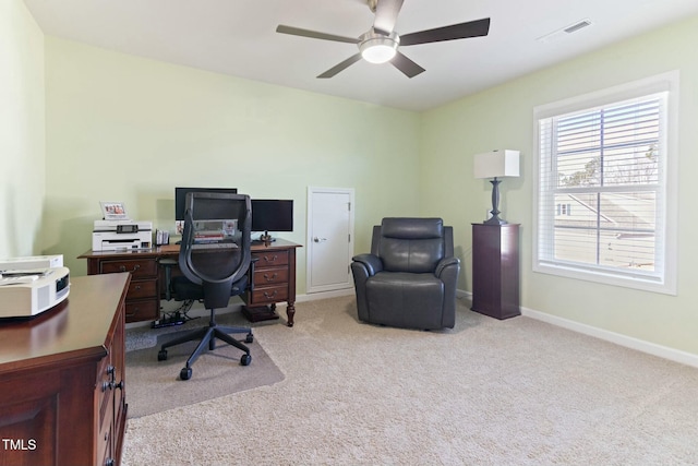 carpeted office featuring visible vents, baseboards, and ceiling fan