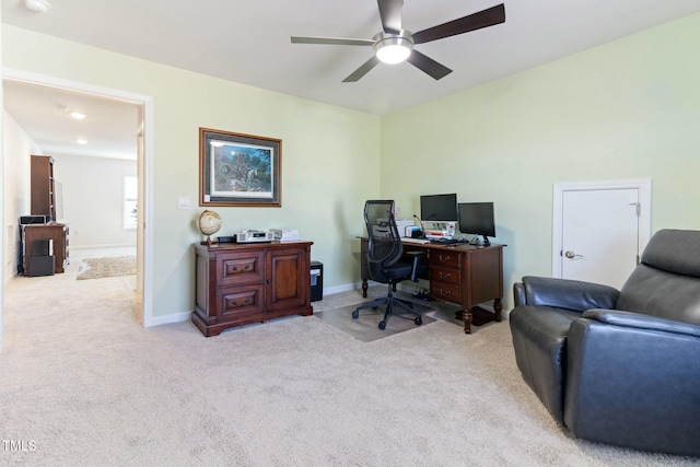 carpeted office with baseboards and ceiling fan