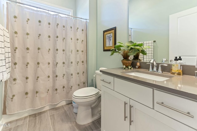 bathroom featuring shower / tub combo, toilet, and vanity