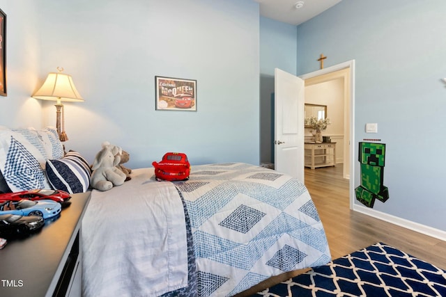 bedroom featuring baseboards and wood finished floors