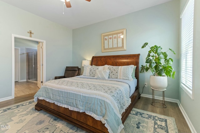 bedroom featuring wood finished floors, baseboards, and ceiling fan