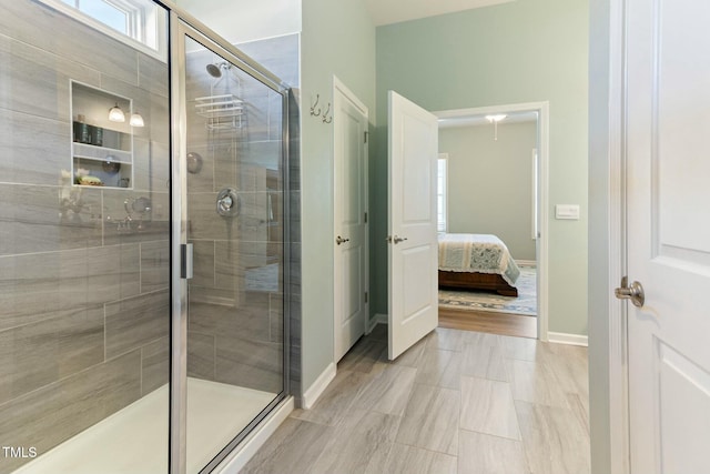 full bathroom with baseboards, ensuite bath, and a stall shower