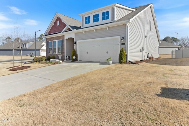 craftsman house featuring a front lawn, driveway, fence, roof with shingles, and an attached garage