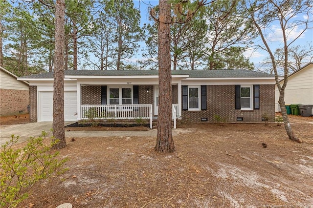 single story home with a porch, concrete driveway, an attached garage, crawl space, and brick siding