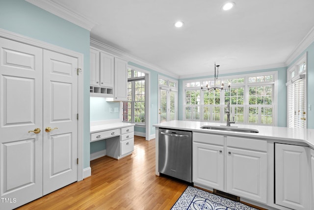 kitchen featuring a sink, light countertops, crown molding, and stainless steel dishwasher