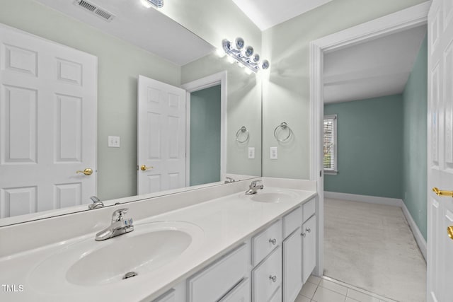 bathroom with a sink, visible vents, double vanity, and tile patterned floors