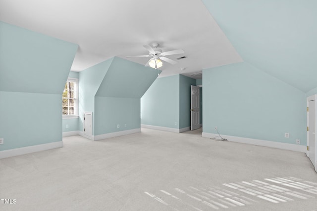 additional living space featuring visible vents, baseboards, carpet, lofted ceiling, and a ceiling fan