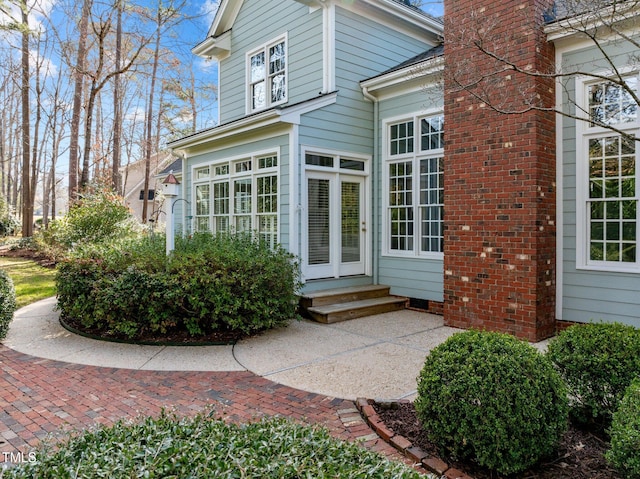 entrance to property featuring a chimney