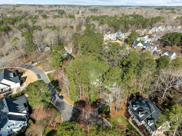 bird's eye view with a wooded view