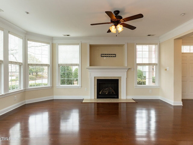 unfurnished living room featuring wood finished floors, a healthy amount of sunlight, and ornamental molding