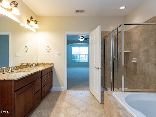 bathroom with double vanity, a stall shower, visible vents, and a sink