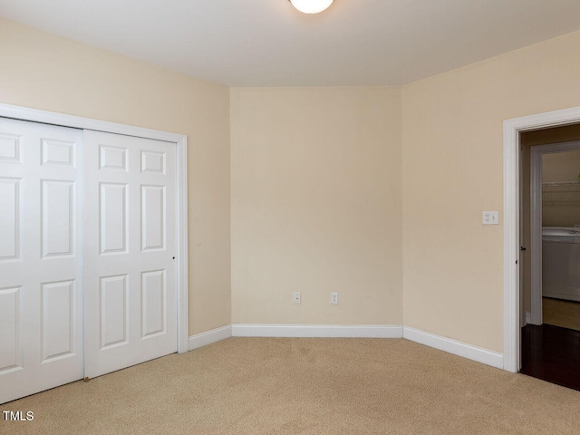 unfurnished bedroom featuring a closet, baseboards, and carpet