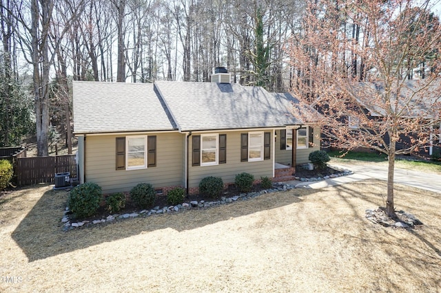 view of front of house with crawl space, fence, driveway, and a shingled roof