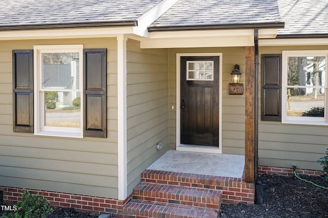 entrance to property featuring crawl space and a shingled roof