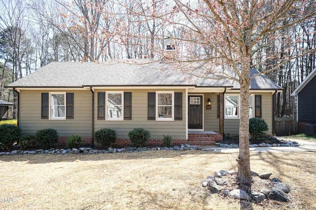 single story home featuring a chimney and a shingled roof