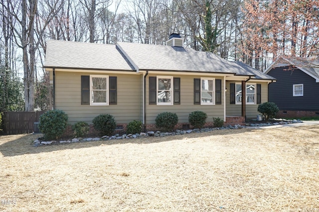 single story home featuring a shingled roof, fence, cooling unit, a chimney, and crawl space