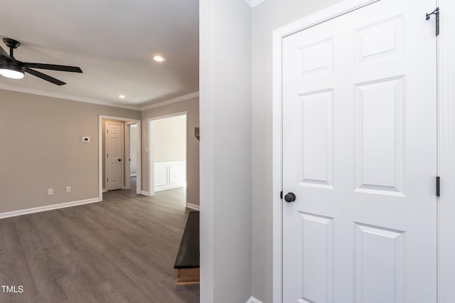 hallway featuring dark wood-style flooring, recessed lighting, baseboards, and ornamental molding