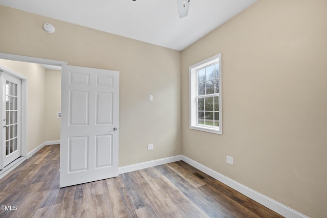 unfurnished bedroom featuring a ceiling fan, baseboards, and wood finished floors