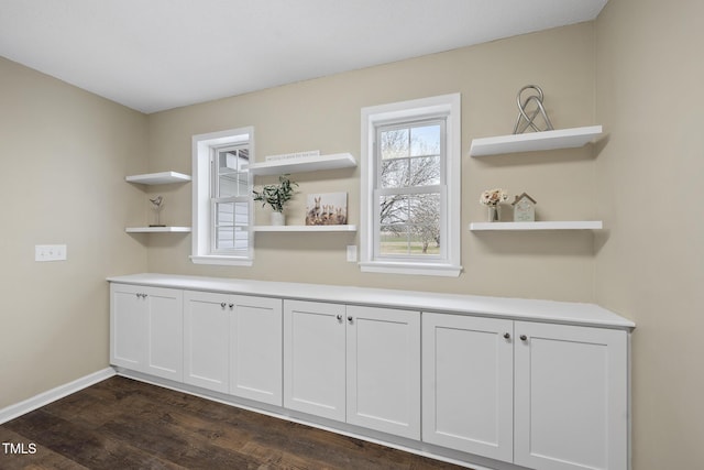 bar with baseboards and dark wood-type flooring