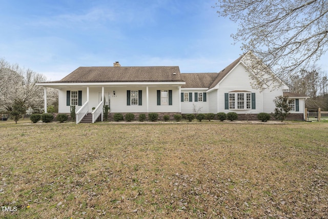 single story home with a chimney, covered porch, and a front yard