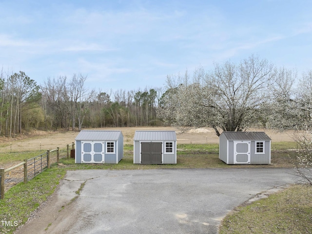 view of shed with fence