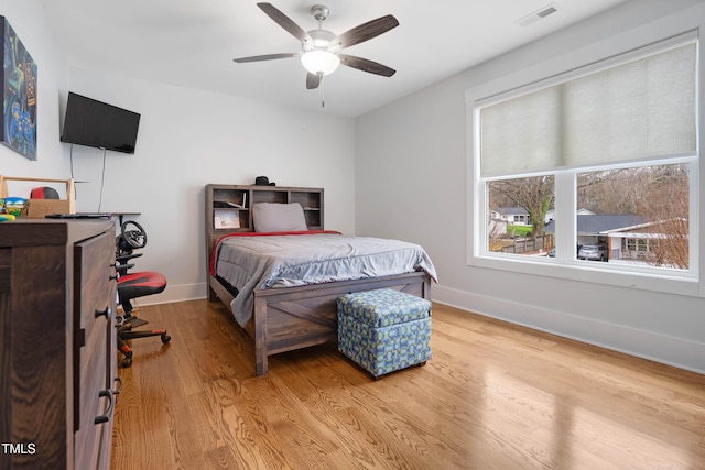 bedroom with visible vents, ceiling fan, light wood-type flooring, and baseboards