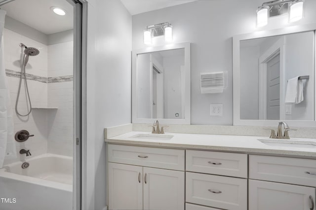 bathroom with double vanity, shower / tub combo with curtain, and a sink