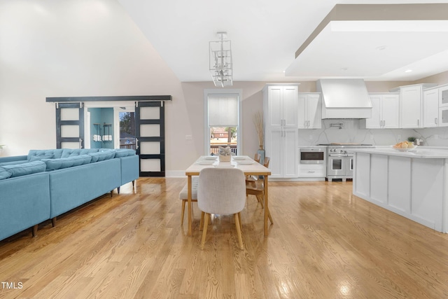 dining space with recessed lighting and light wood-style floors