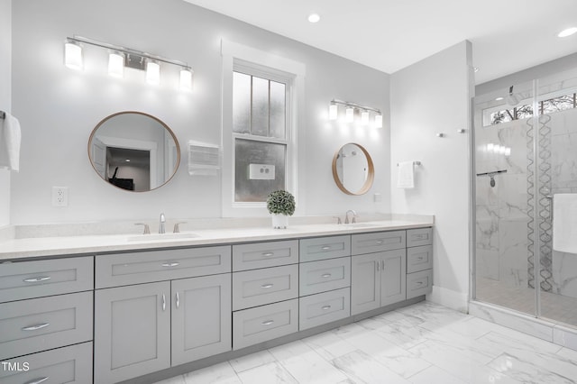 full bath featuring marble finish floor, tiled shower, and a sink