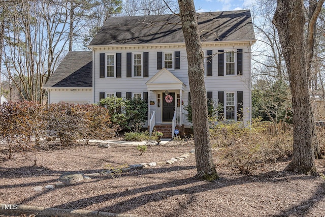 colonial-style house featuring an attached garage