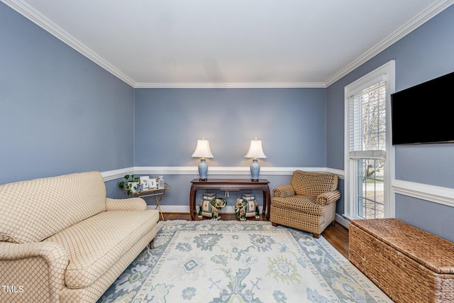 sitting room featuring crown molding and wood finished floors