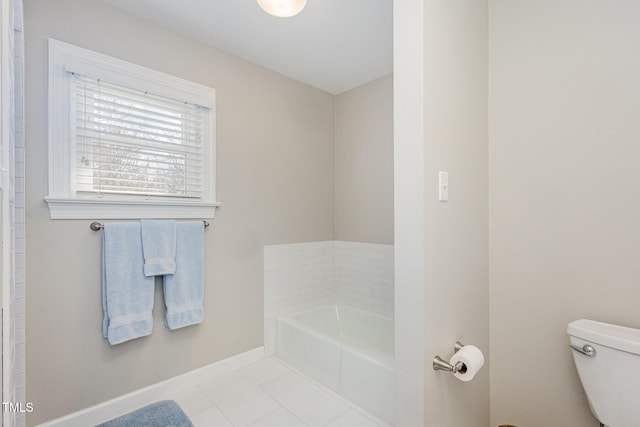 full bath with tile patterned floors, baseboards, toilet, and a garden tub