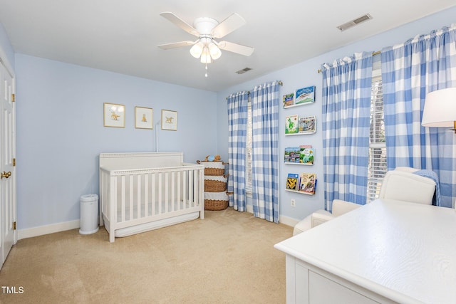 bedroom featuring visible vents, light carpet, baseboards, and a ceiling fan