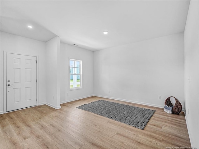 interior space with recessed lighting, baseboards, and wood finished floors