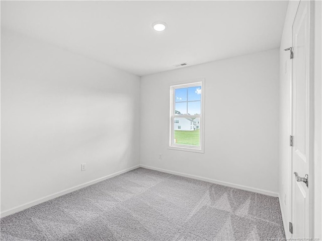 carpeted spare room featuring visible vents, recessed lighting, and baseboards