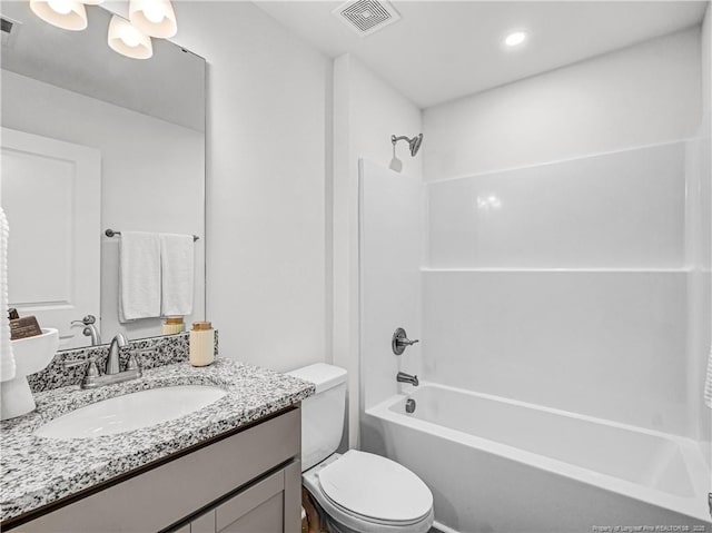 full bathroom with toilet, visible vents, bathtub / shower combination, and vanity
