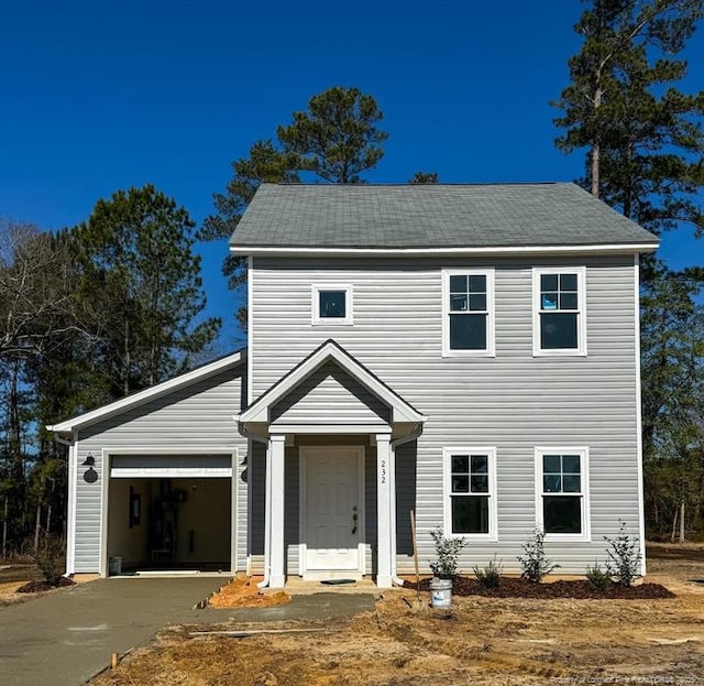 colonial-style house with driveway and an attached garage