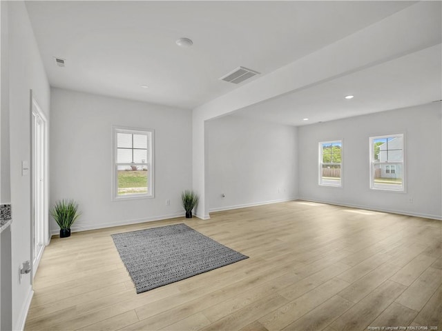 spare room with recessed lighting, baseboards, light wood finished floors, and visible vents
