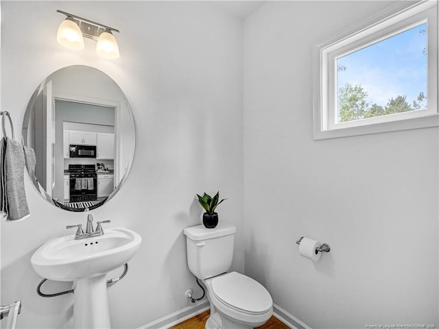 bathroom with baseboards and toilet