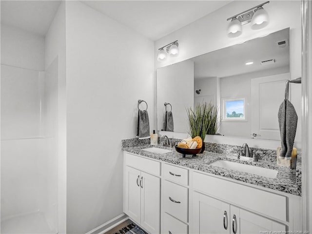full bath featuring double vanity and a sink