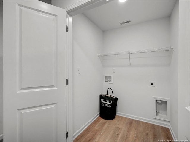 laundry area featuring hookup for a washing machine, baseboards, electric dryer hookup, wood finished floors, and visible vents