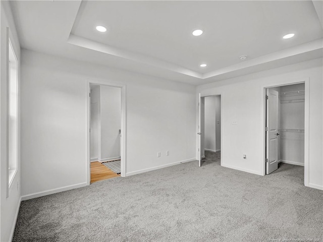 232 Penfield Way, Raeford, NC 28376 - unfurnished bedroom featuring carpet floors, a raised ceiling, baseboards, recessed lighting, and a spacious closet