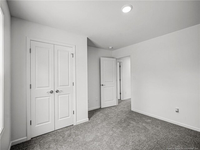 232 Penfield Way, Raeford, NC 28376 - unfurnished bedroom featuring carpet floors, baseboards, and a closet