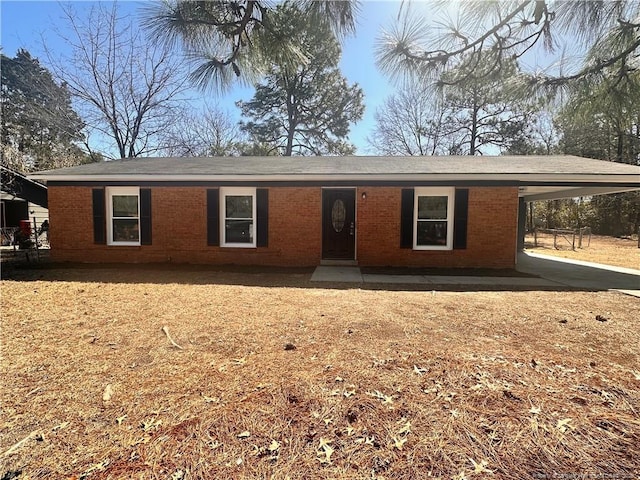 ranch-style home with brick siding and a carport