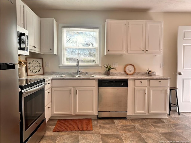 kitchen with a sink, light countertops, white cabinetry, and stainless steel appliances