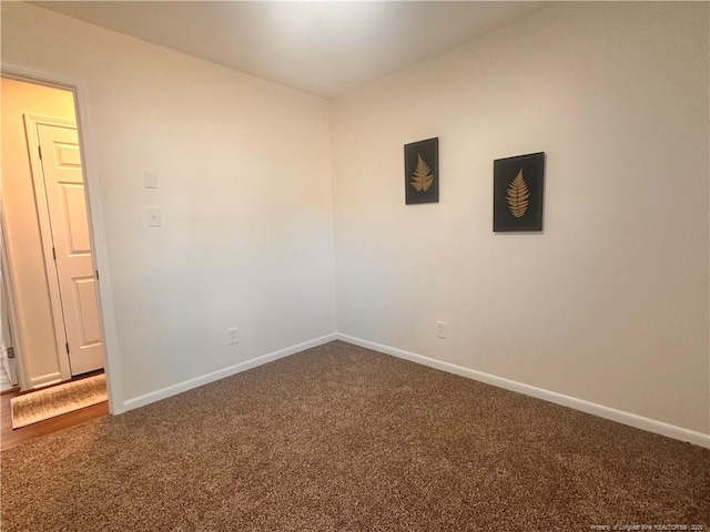 carpeted spare room with baseboards