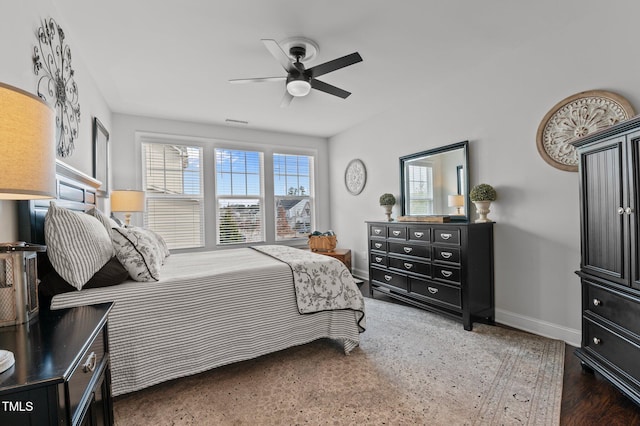 bedroom with ceiling fan, baseboards, and wood finished floors