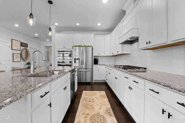 kitchen with crown molding, dark wood finished floors, appliances with stainless steel finishes, white cabinetry, and a sink