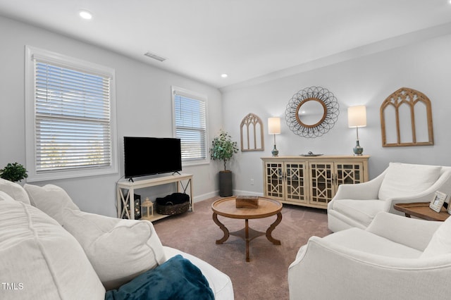 living area with recessed lighting, carpet flooring, baseboards, and visible vents