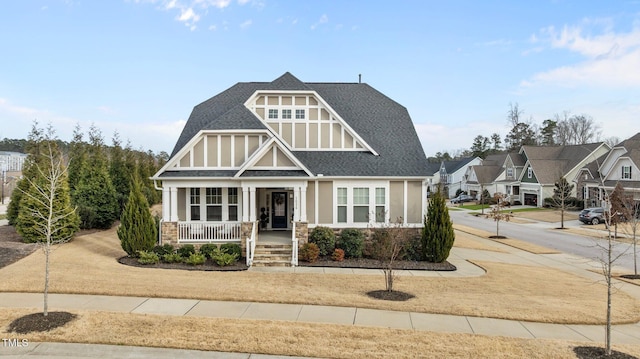 view of front of house with a porch, a residential view, and roof with shingles